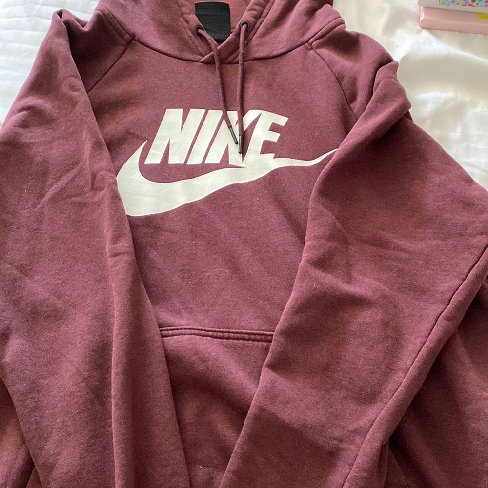Woman’s maroon Nike hoodie